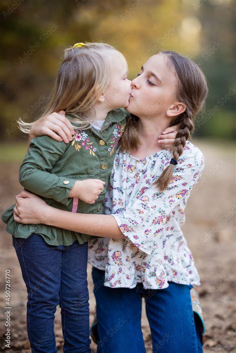 sister kissing sister